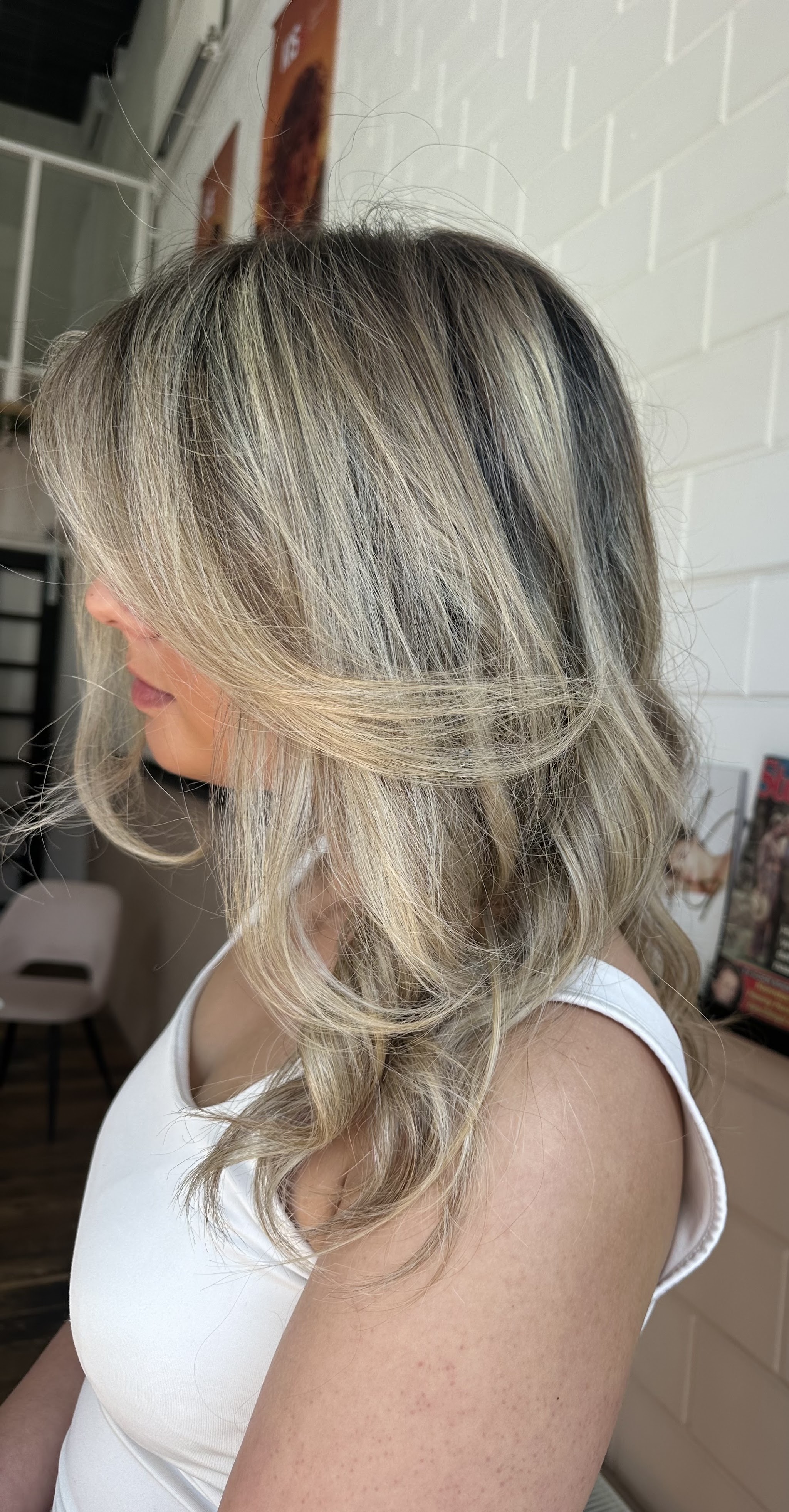 Koel blond met een zachte blend, gestyled in de salon